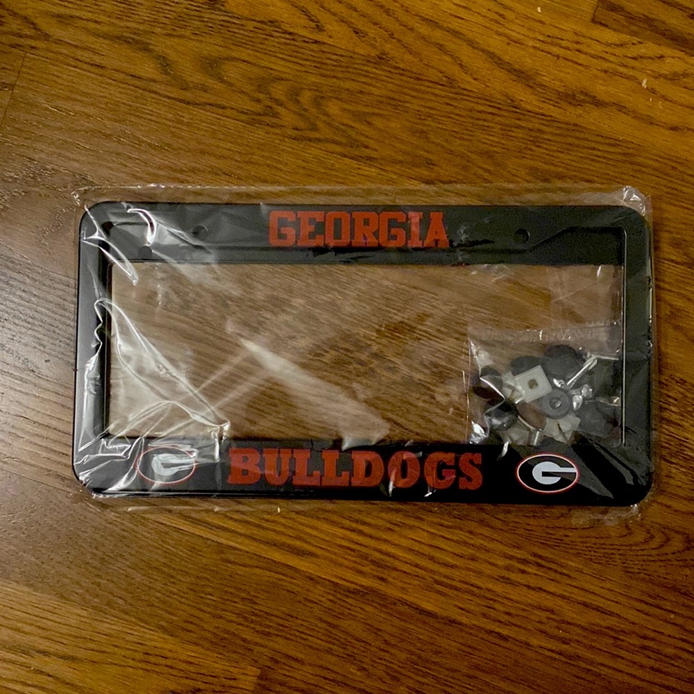 2 piece UGA license plate holder frames. Brand new. Still in original packaging.